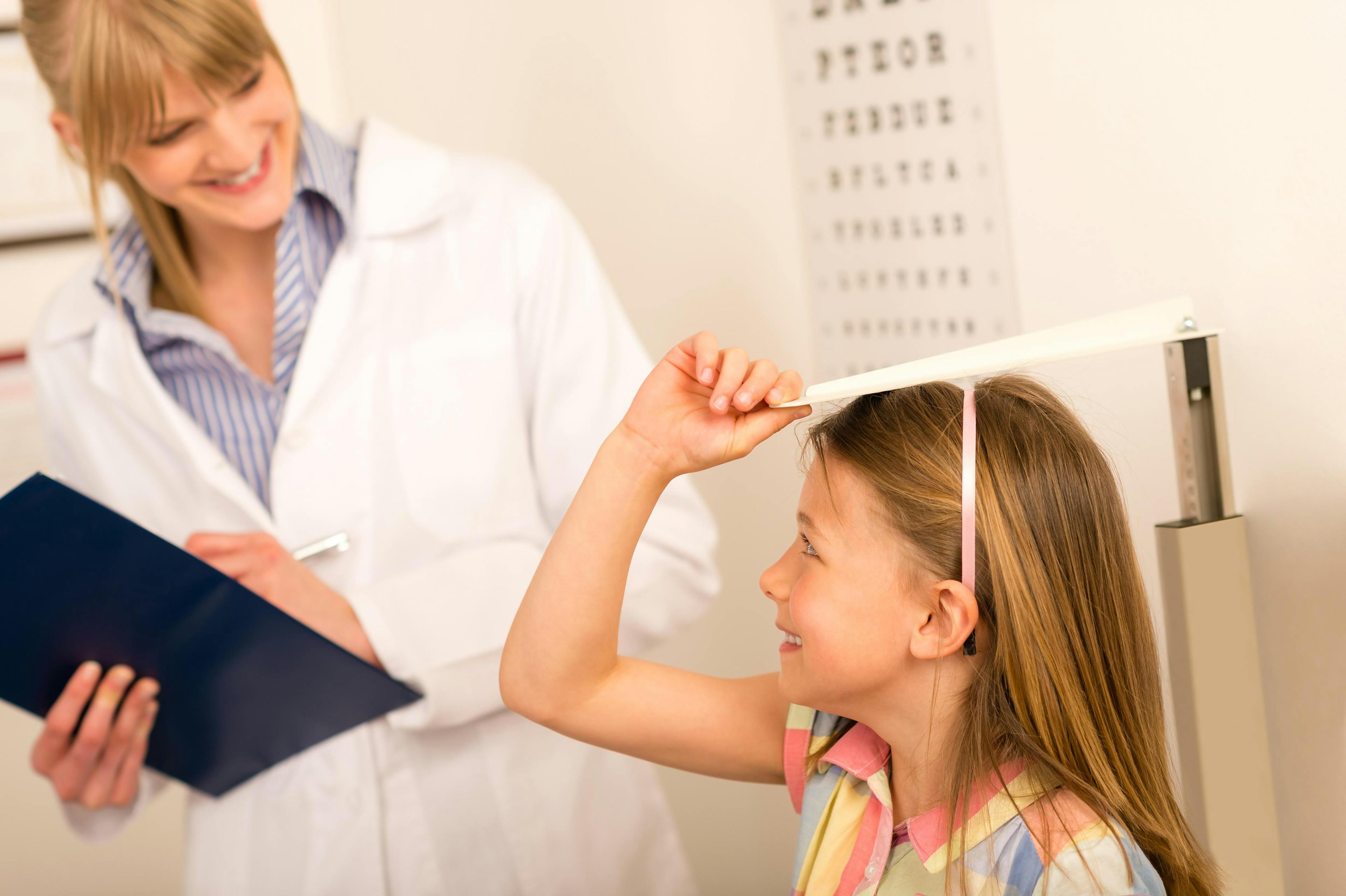 Child being measured during a pediatrician visit