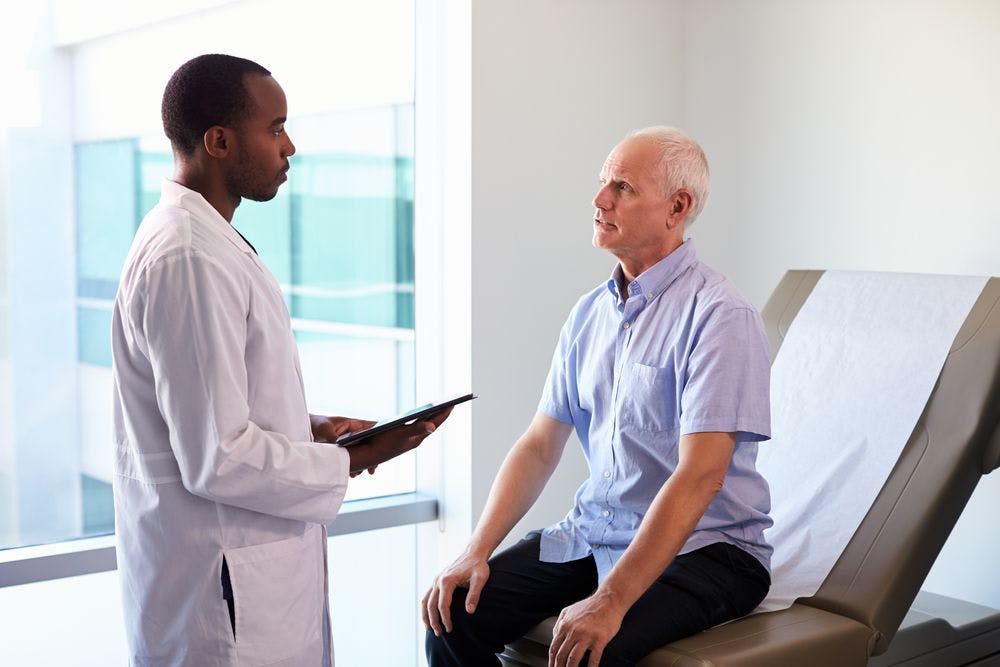 Doctor talking to a patient about statins. 