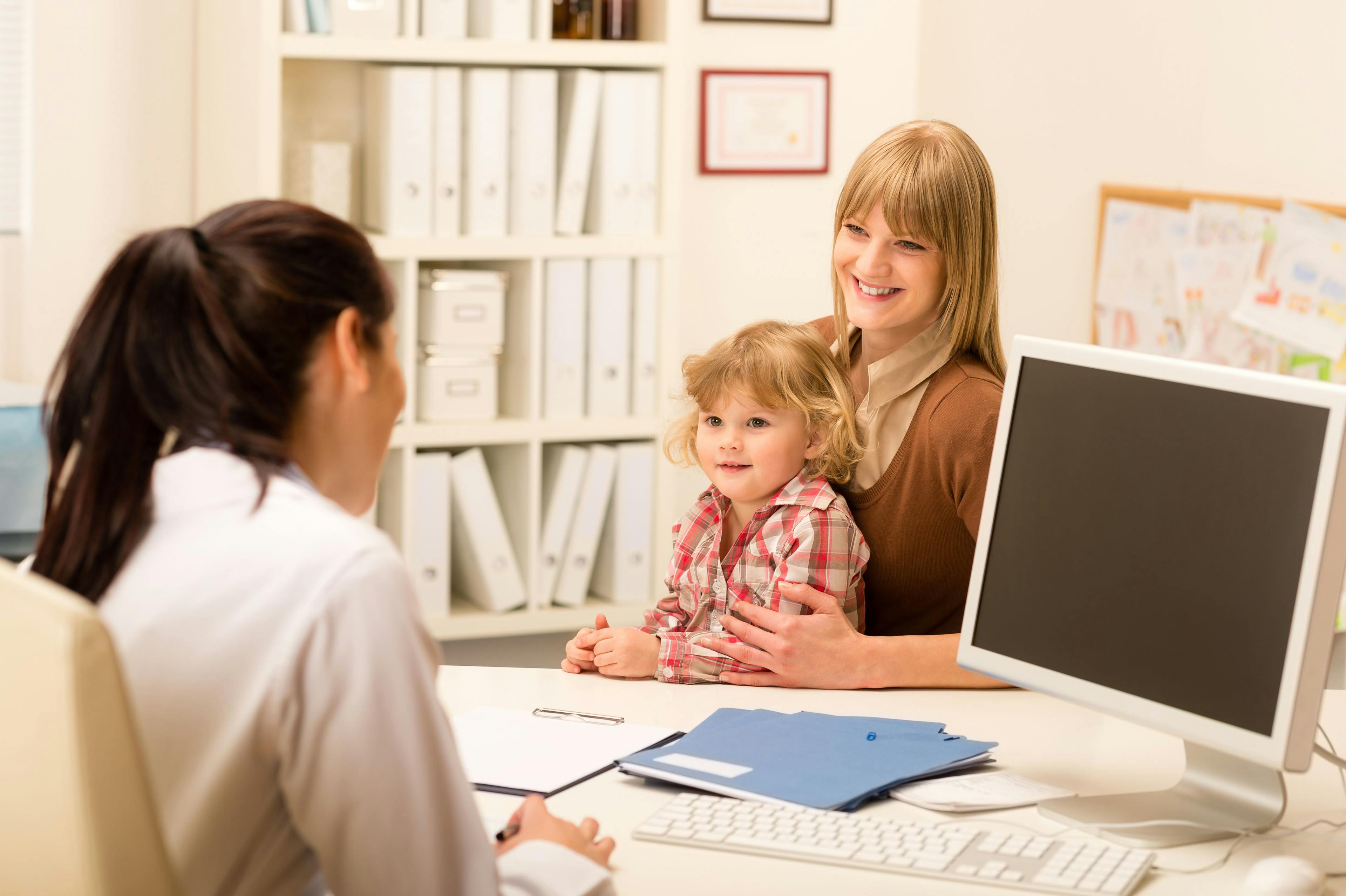 Mother and child sitting with doctor | Credit: Fotolia