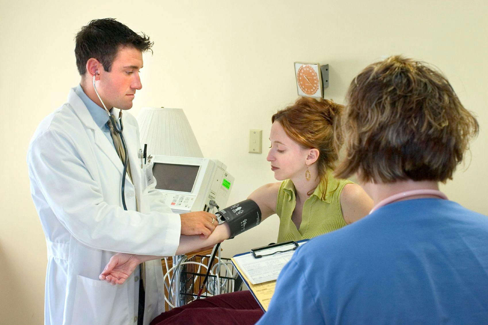 Stock art of a younger female patient getting her blood pressure measured