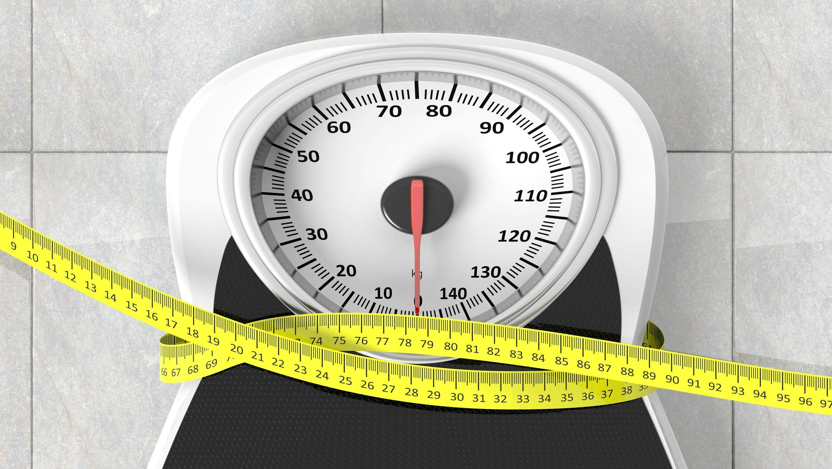 Image of a scale with a measuring tape wrapped around it
