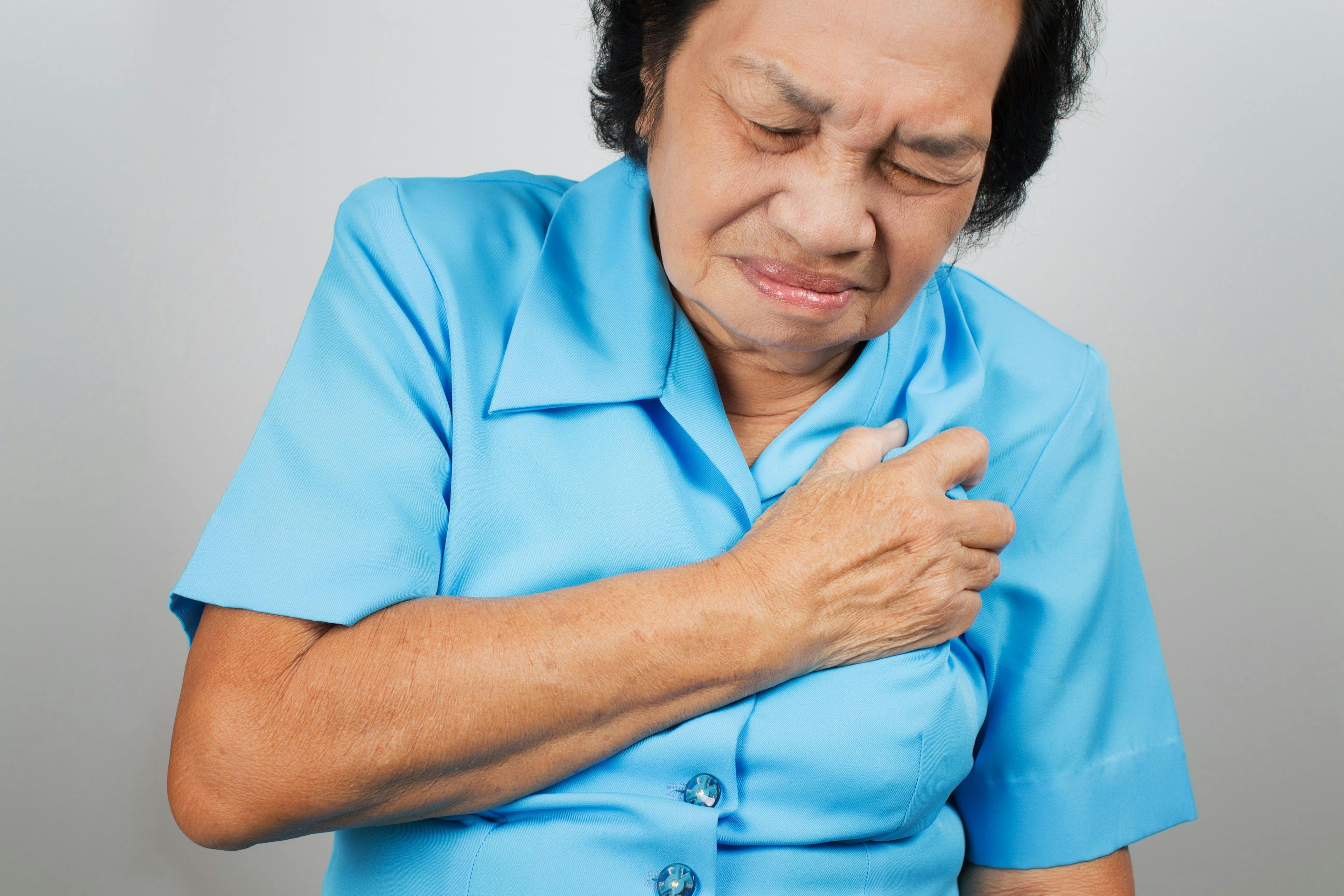 Older woman grabbing at her chest in pain
