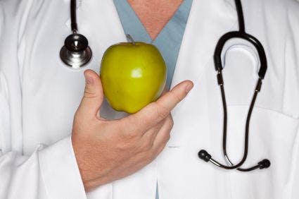 Stock art of a healthcare provider holding an apple