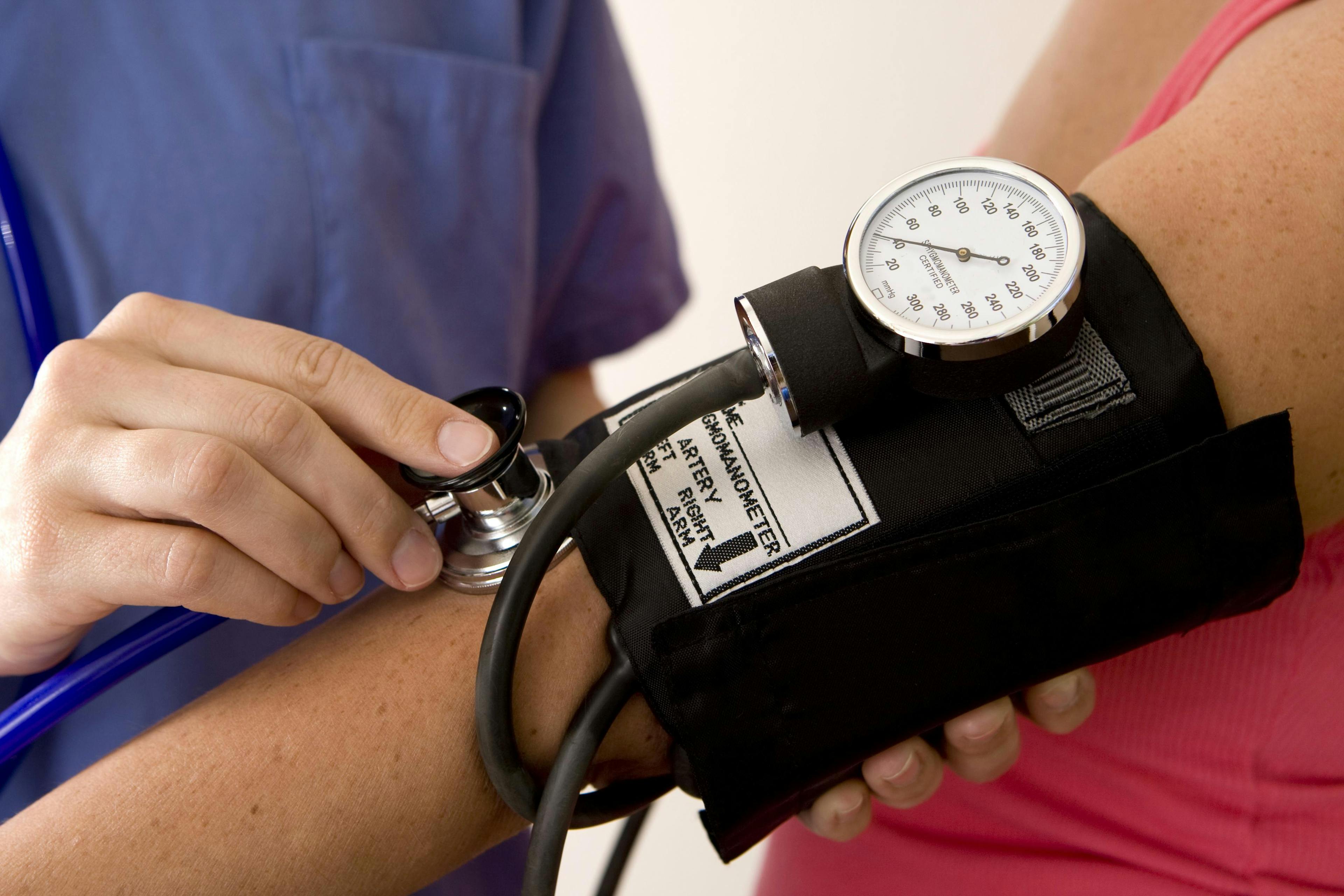 Blood pressure cuff around a woman's arm.