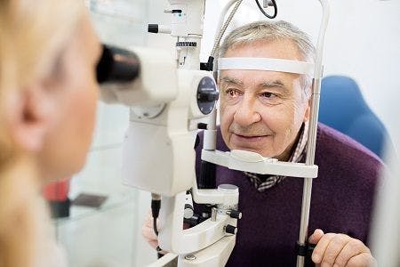 Eye doctor examines patient