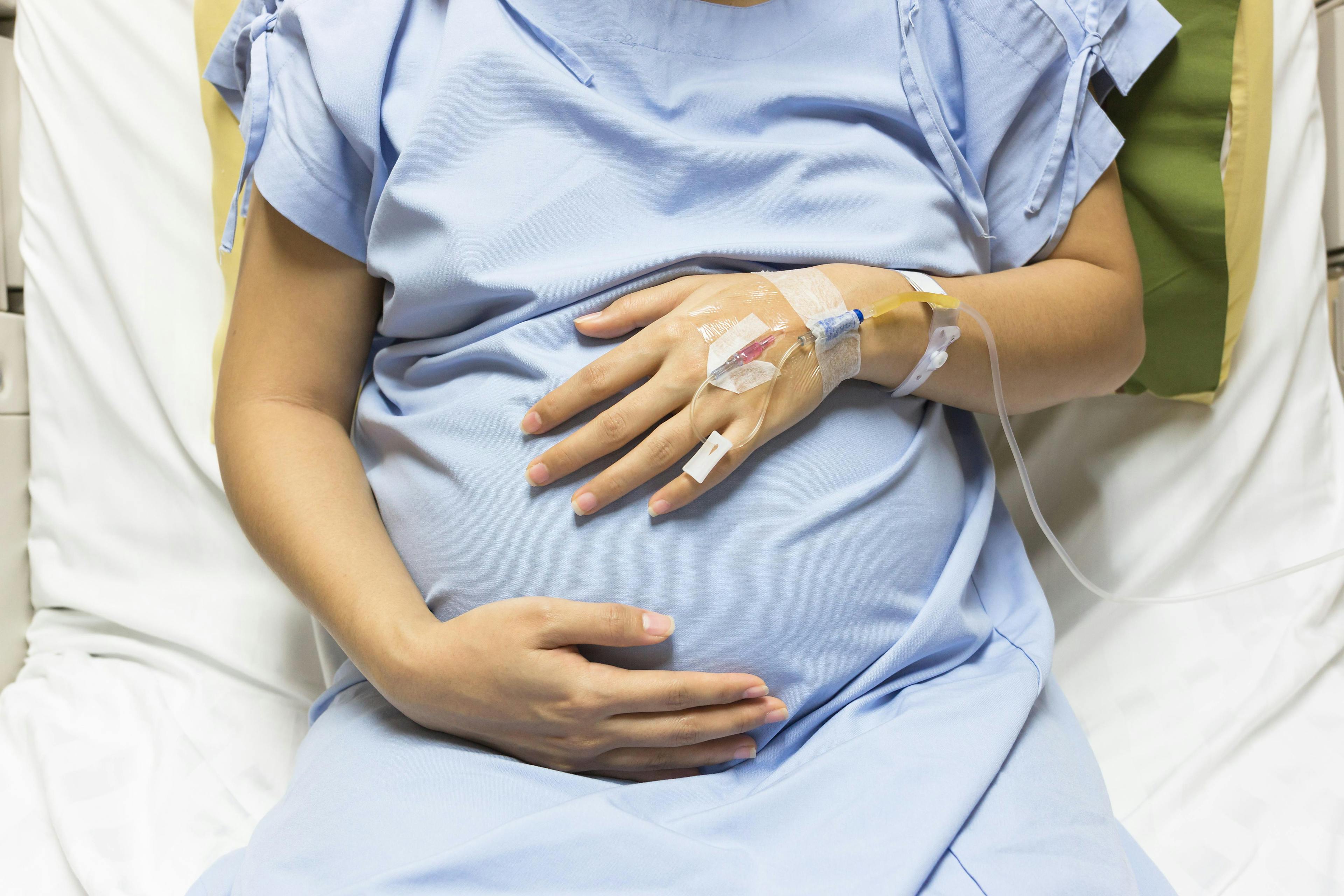 A pregnant woman in a hospital bed.