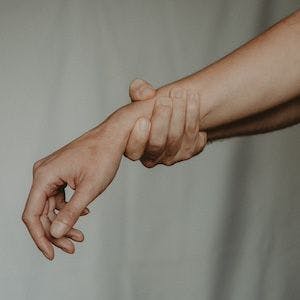 Holding onto one's wrist | Image Credit: Pexels/Anete Lusina
