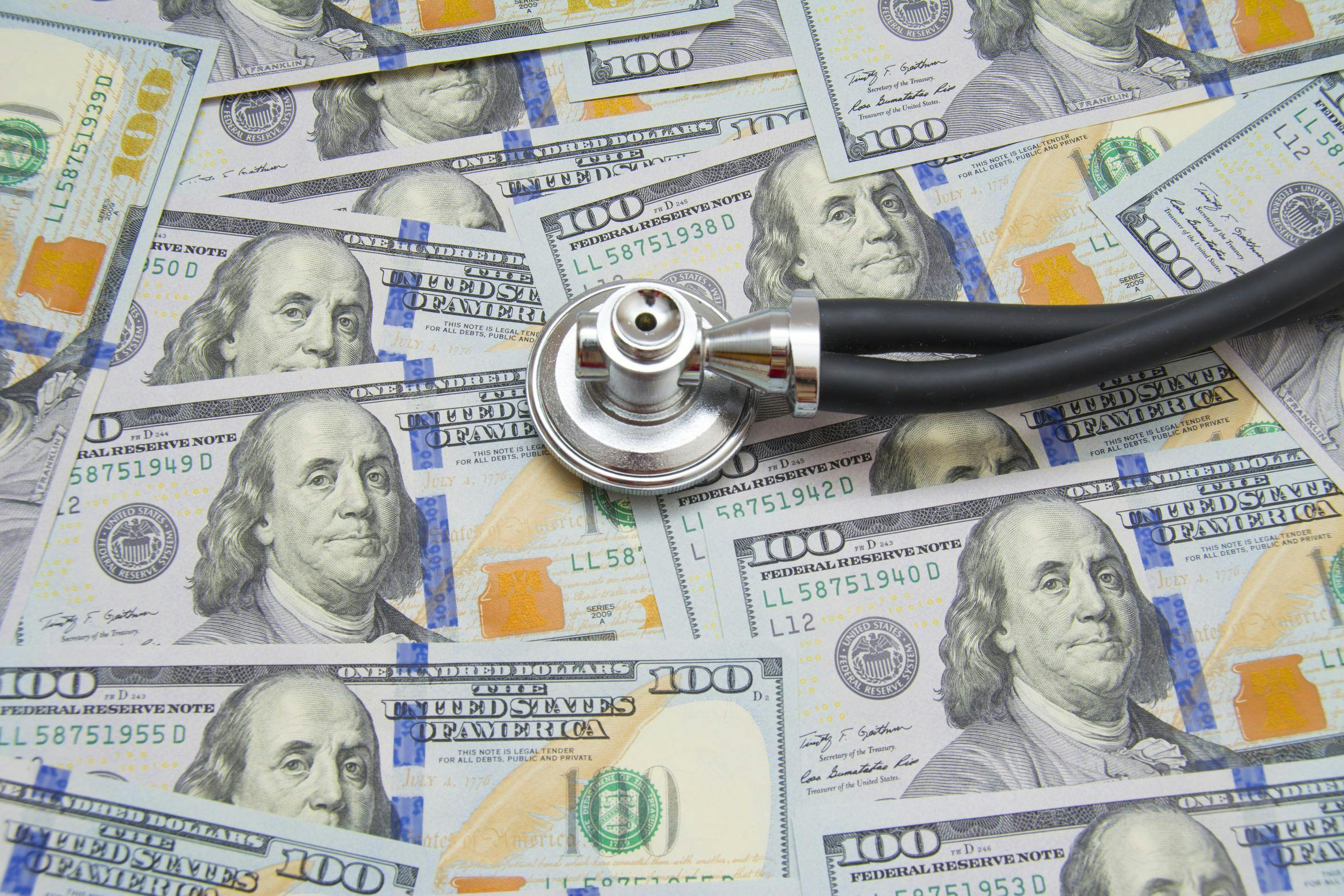 Stethoscope on top of a pile of money.
