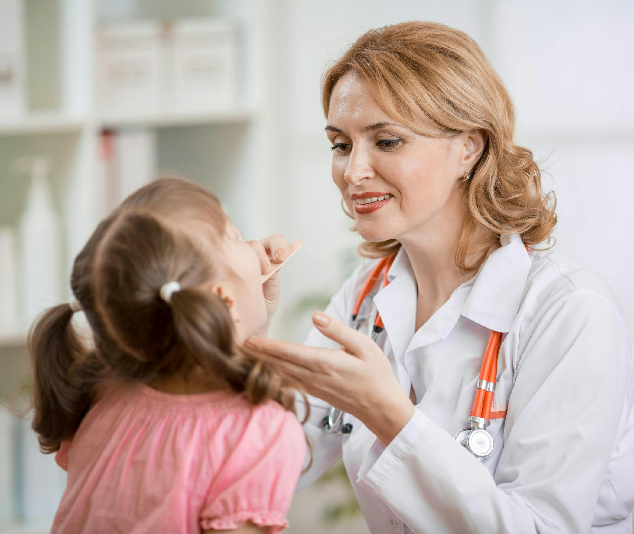 Pediatrician treating a patient.